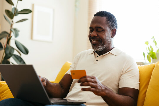 Middle age man doing some online shopping with credit card