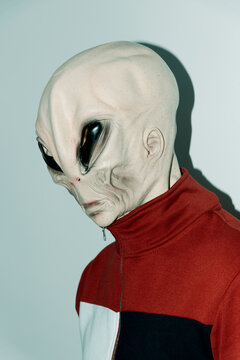 man wearing an alien mask
