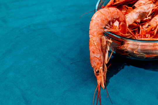 raw red prawns in an oval glass tray