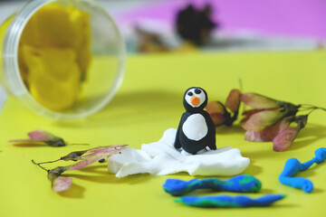Child making crafts from plasticine, paper, natural dry plants, flowers, grass . Back to school. Ideas for children's art
