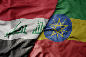 big waving national colorful flag of ethiopia and national flag of iraq.