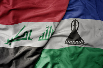 big waving national colorful flag of lesotho and national flag of iraq.