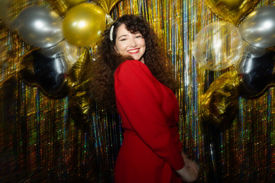 Lady in red. Woman with long hair and curlers