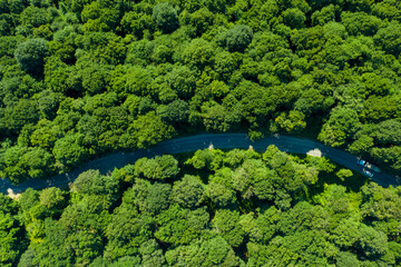 Aerial view of a road in the middle of the forest , road curve construction up to mountain