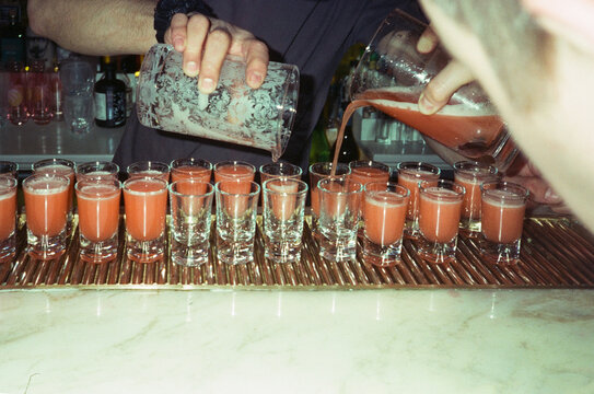 Friends preparing fruit shots at party to celebrate new year