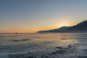 Fototapeta na wymiar Touristic activities on Lake Baikal, Russia, during the winter season and on the freezing water