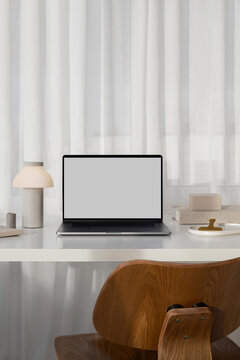 Mockup modern laptop with white screen in a stylish office