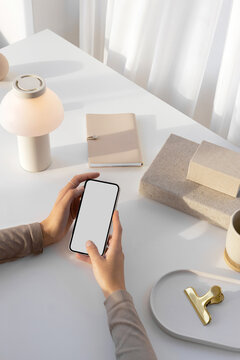 Mockup of a modern phone with white  screen. bright workplace