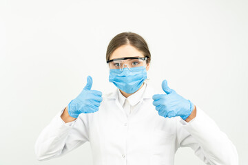 Satisfied young female doctor receive good results on studying virus, discover vaccine, show thumb-up, wear face mask and gloves