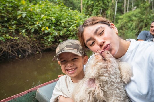 Happy siblings with their dog
