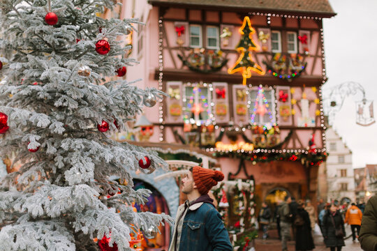 Man in a Christmas Village full of decorations