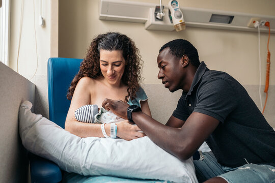 Multicultural couple in the hospital room after giving birth
