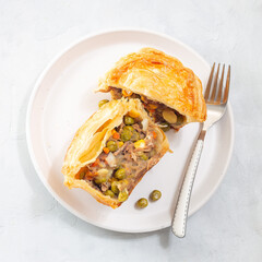 Sliced beef pot pie on plate, top view, square