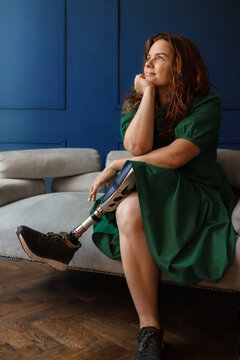 Portrait of a happy disabled person with a prosthetic leg at home
