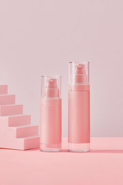 Skin care lotion bottles on pink background