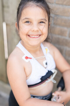 Little girl with a mobile Holter Cardio monitor 