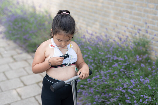 girl touching her mobile Holter Cardio monitor 