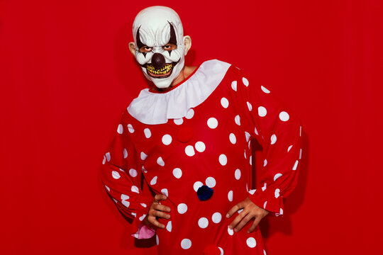 clown in a red costume posing like a model
