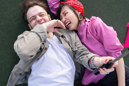 Diverse queer bloggers shooting video on sports ground