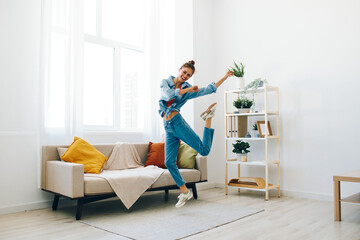 Joyful Woman Jumping and Dancing in Happy Home Lifestyle