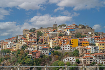 Fototapeta na wymiar Residential houses with colorful facades on a hill in Greek city Kavala