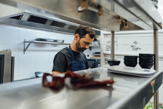 Male chef preparing food in kitchen