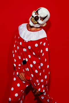clown posing wearing a red costume