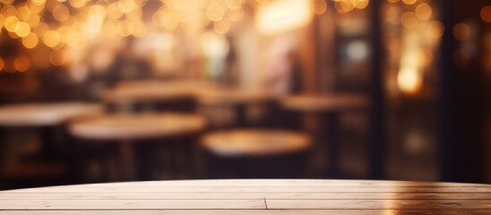 A close-up view of an empty table in a coffee shop, with a defocused background creating a blurred effect. The table is the focal point, showcasing its details and texture.