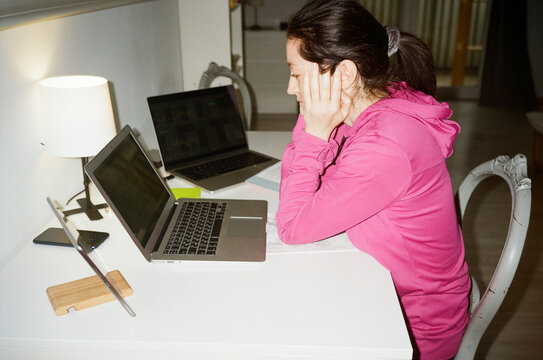 Amateur film shot with a girl working with laptops at home