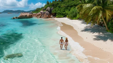 Foto op Plexiglas Drone view of a young couple of men and women on a tropical beach during a luxury vacation in Seychelles. © Fokke Baarssen