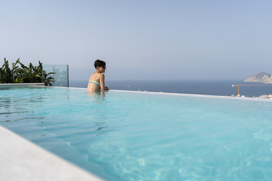 Woman in an infinity pool.