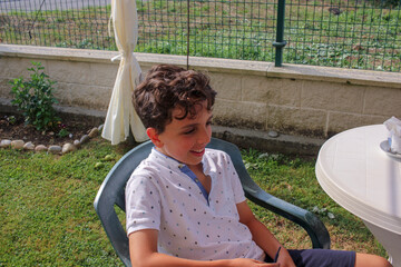 boy having fun in a chair in the garden