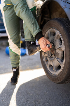 Man changing the tire of his car.