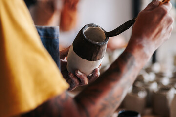 Detail shot of the hands of a male potter