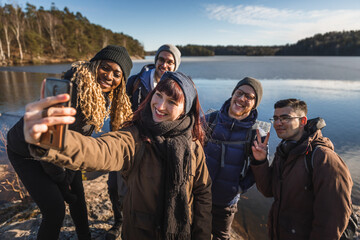 Taking a selfie by a lake