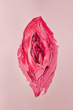 Texture paint brush strokes creating female vulva on pink canvas