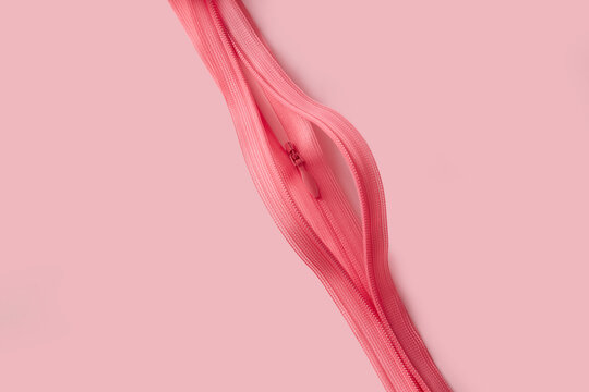 Two pink open zippers depicting abstract shape of female vagina