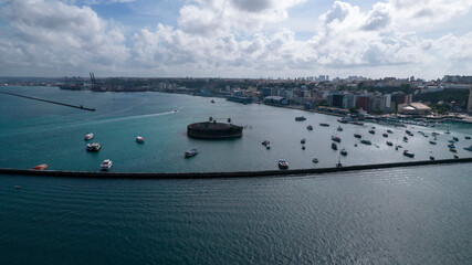 Aerial view from the ocean to port with breakwater protecting anchored boats