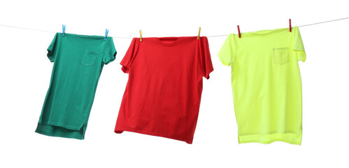 Colorful t-shirts drying on washing line isolated on white