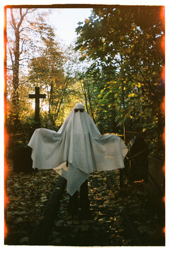 Cute ghost posing at the cemetery