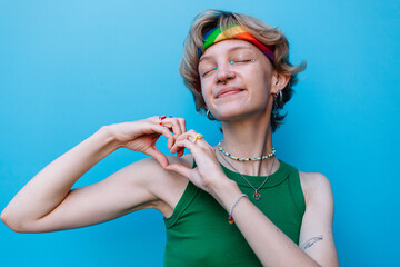 Happy lgbtq hippie woman with hands showing heart and love
