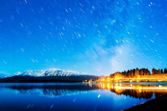 Star trail reflections with snow capped mountains