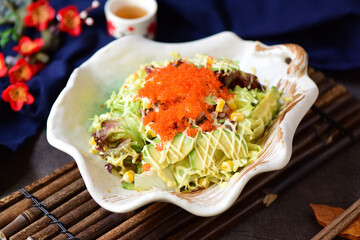 Delicious crab, tuna, fruit and vegetable salad on a plate