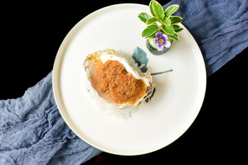 Garlic charcoal grilled oysters placed on a plate
