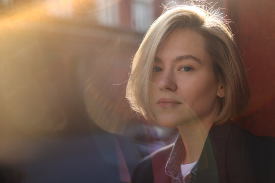 Formal blond woman looking at the camera with sunlight effect