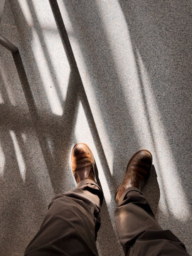 Man's feet with boots and shadows