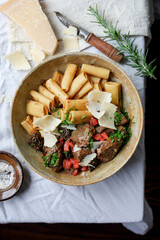 French beef ragout served on a rustic table setting, accompanied by parmesan cheese.