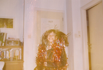 A girl jumping with a tinsel outfit