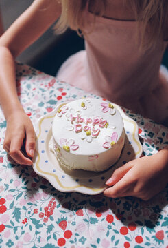 A girl with a mini cake
