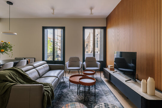 bright and cozy living room with wood slat wall